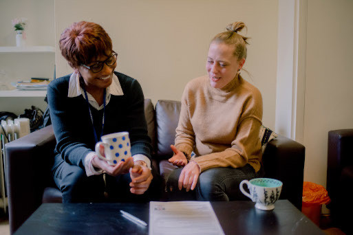 Two women chatting with coffee